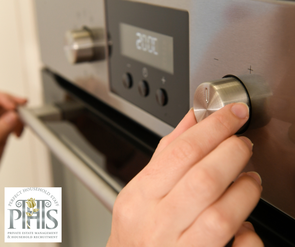 Housekeeper inspecting an oven, demonstrating housekeeping problem-solving skills to prevent potential issues and ensure smooth household operations.