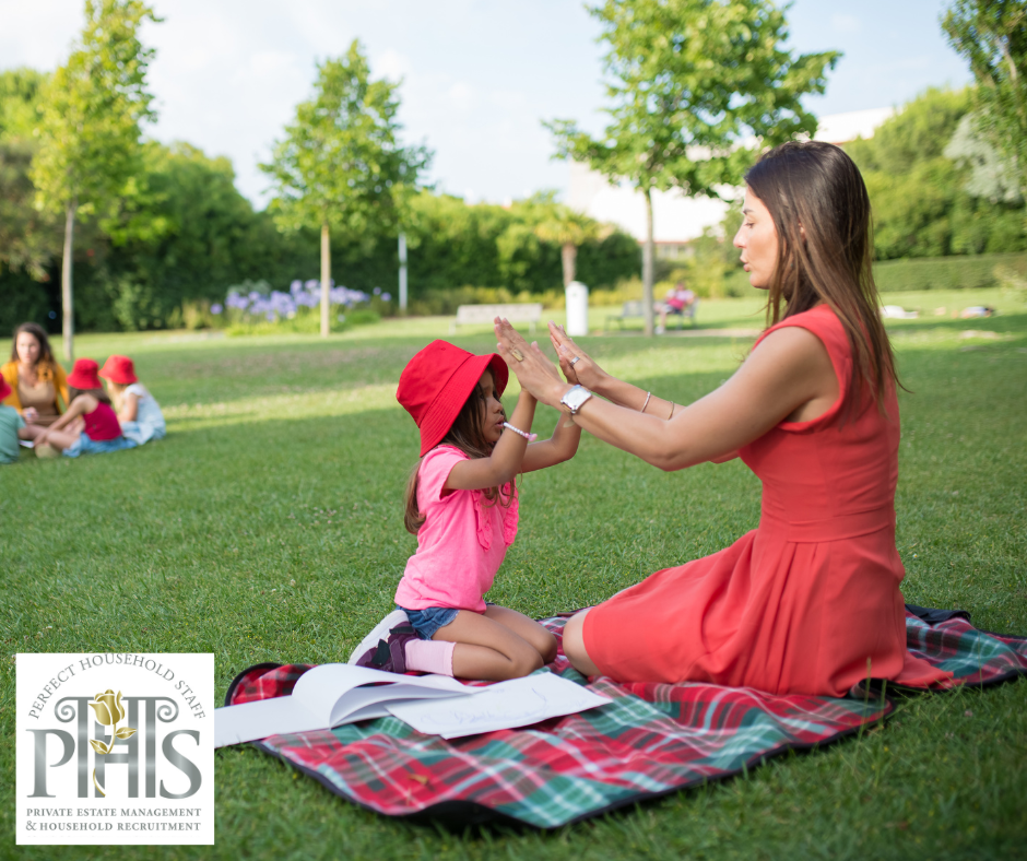 Nanny with child in the park, performing essential nanny tasks