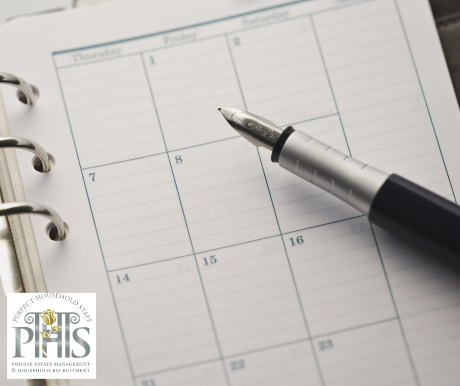 Housekeeper reviewing the household calendar to anticipate problems in housekeeping and plan tasks efficiently.