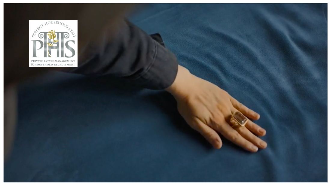 Professional housekeeper making a bed in an elegant residence through a specialist private housekeeper agency Bricket Wood