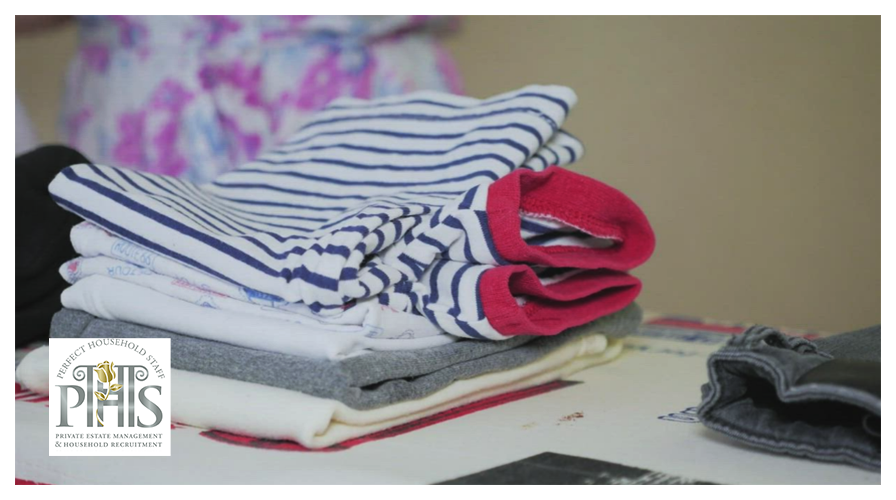 Laundress jobs Saudi Arabia: neatly ironed luxury garments hanging in Riyadh villa laundry